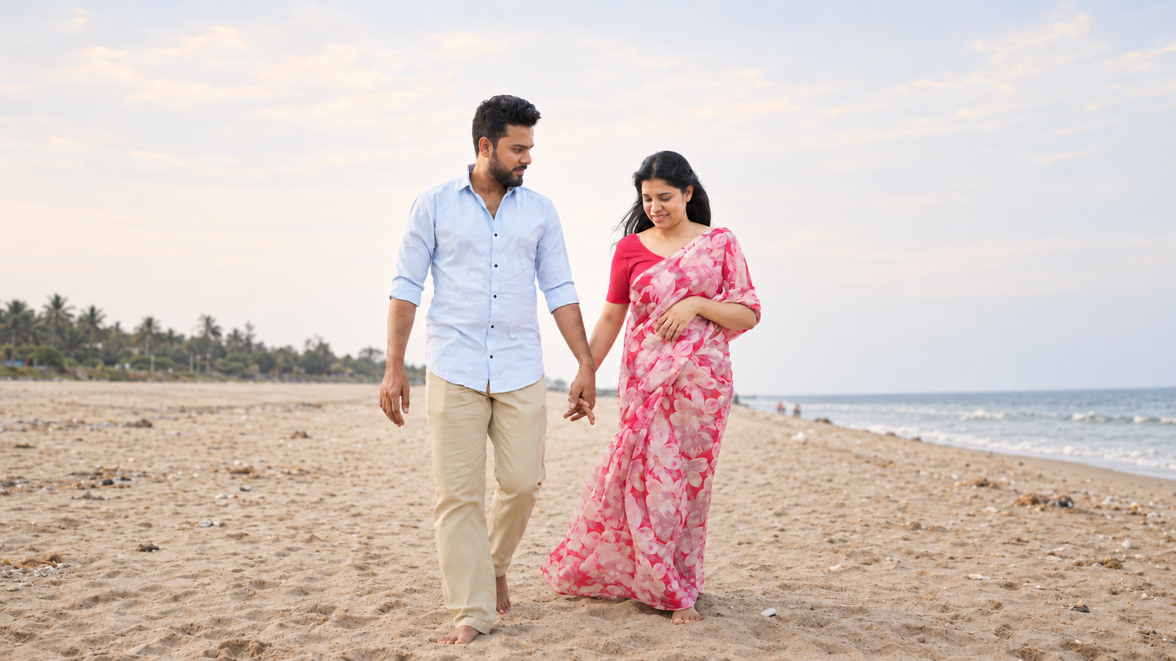 Couple walking hand in hand beside the sea