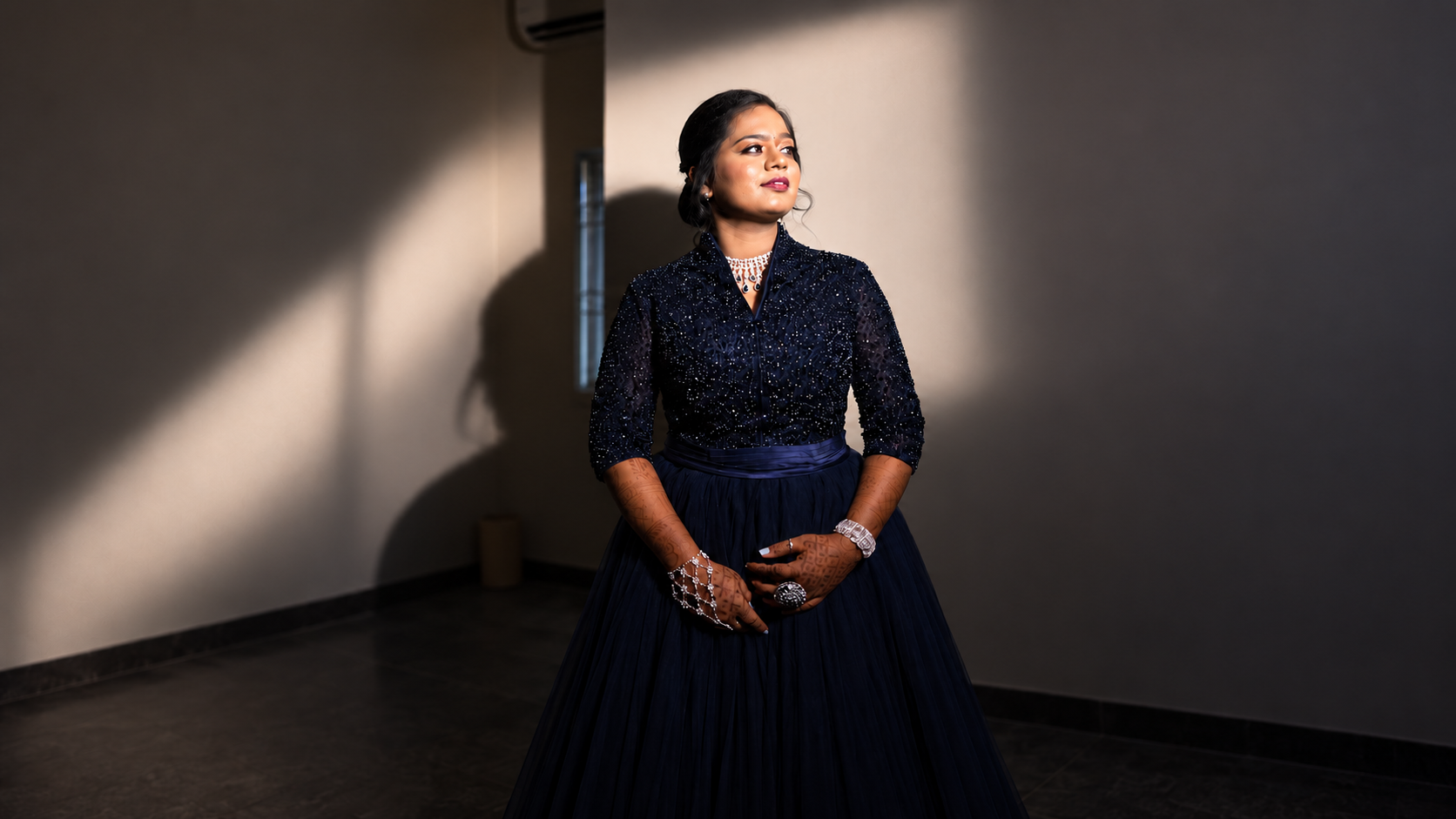 Portrait in a navy gown with soft window light
